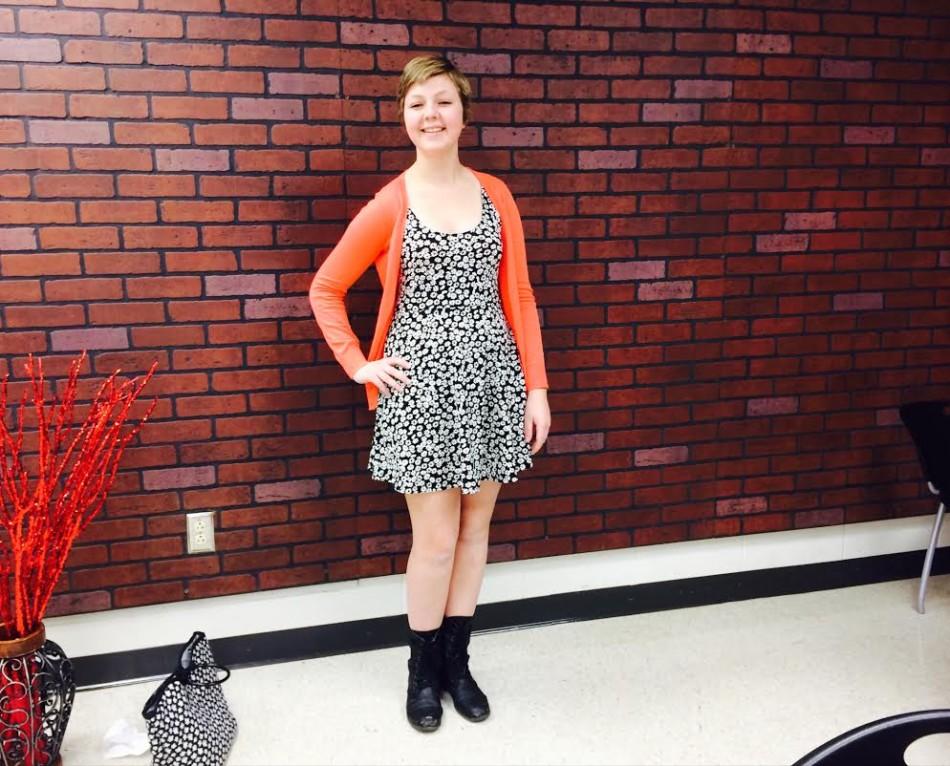 Emily Bartz-Mills (11) poses her best spring fashion outfit, including a flower printed dress with an orange cardigan and combat boots.  