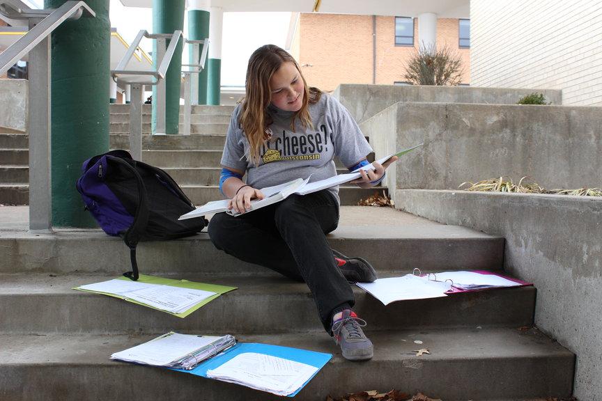 Amanda Aiken (10)  anxiously  checks her homework before class.