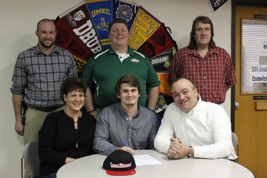 Logan Offner was surrounded by his coaches and parents when officially signing off to play football for Central Missouri State University.