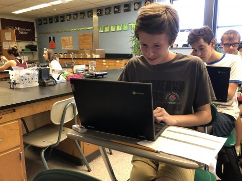 Martyn Seeker (12) works on a chemistry lab assignment in Mr. Dougherty’s class, using one of the district-provided Chromebooks.
