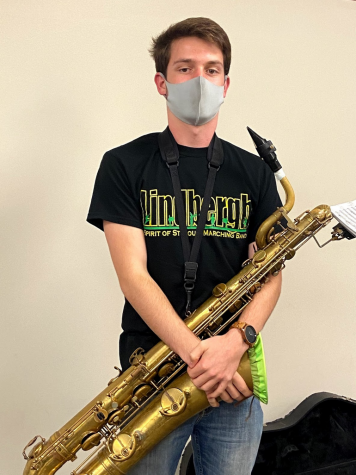 Tyler Thomas (12) stands confident, ready to lead the band at the home football game against SLUH. 