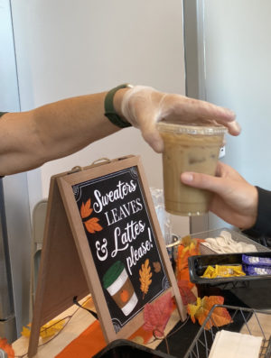 Lydia Krob (10) receives her coffee order from the Coffee Counter. Krob is a regular customer, getting the school coffee multiple times a week. Photo by Elizabeth Cleary.

