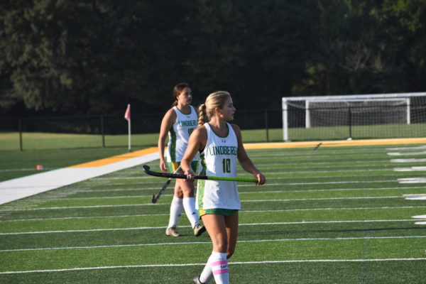 Zoe Earley and Isabella Adams take the field at their varsity field hockey match.