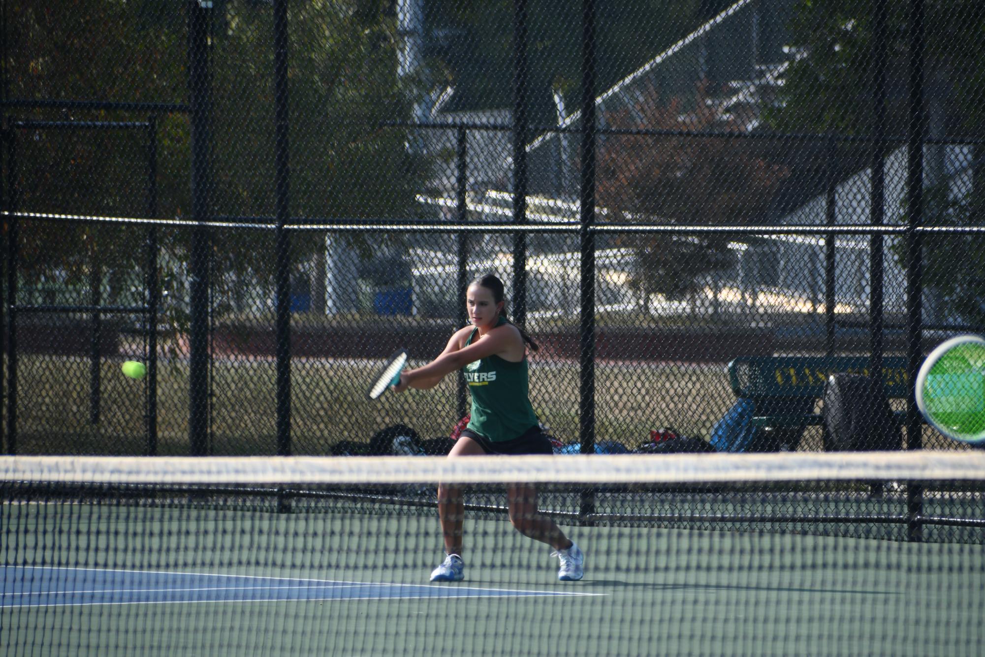 Freshman Grace Lietner returns a serve with a backhand during a match on September 10th against the Ladue Rams. Although the team lost 0-9, Grace performed well, winning both her doubles and singles matches.  “Even though we lost, I still thought our team put up a good fight and I enjoyed seeing their determination”.
