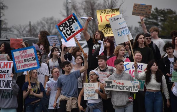 Students protest on the sidewalk of Lindbergh Blvd. 