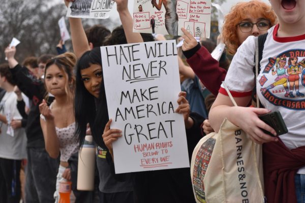 A Lindbergh freshman holds up a sign reading, "Hate will never make America great. Human rights belong to everyone" at the protest.