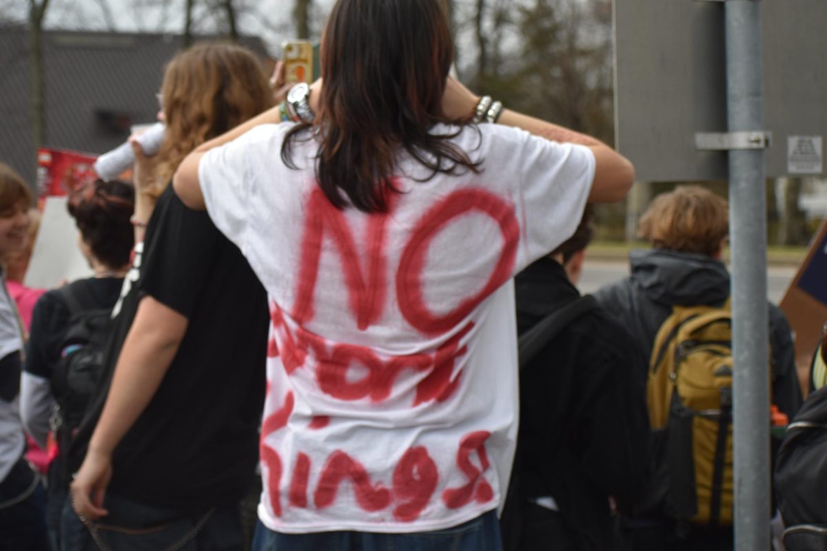A Lindbergh freshman is seen wearing a spray-painted t-shirt reading, "No more kings!" 