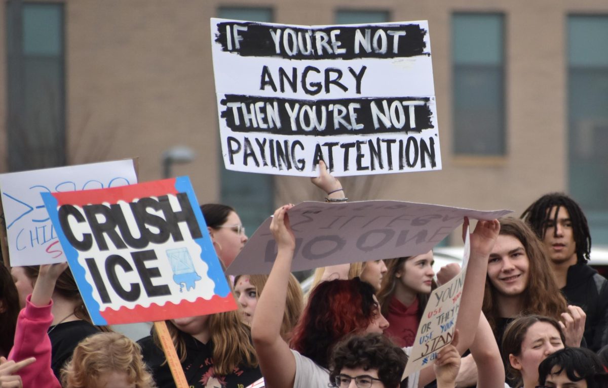 Students hold up signs and chant during the protest.