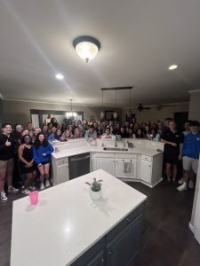 Seniors stand in Dr. Cochran's house after the "break-in"